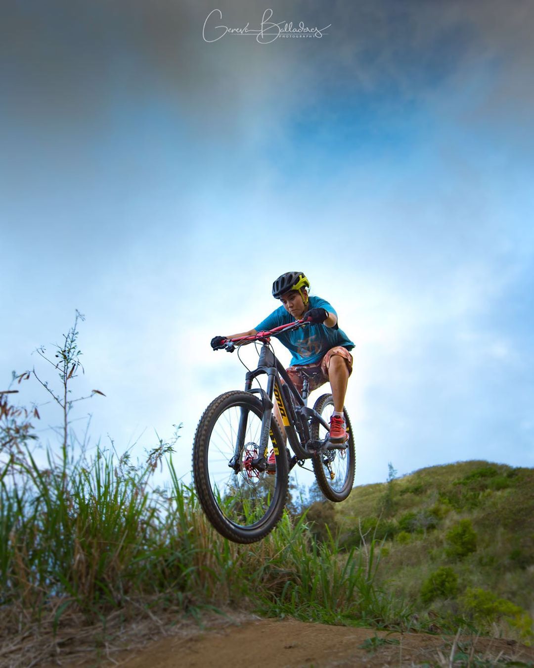 photo: dirt bike catching some air on an off-road trail