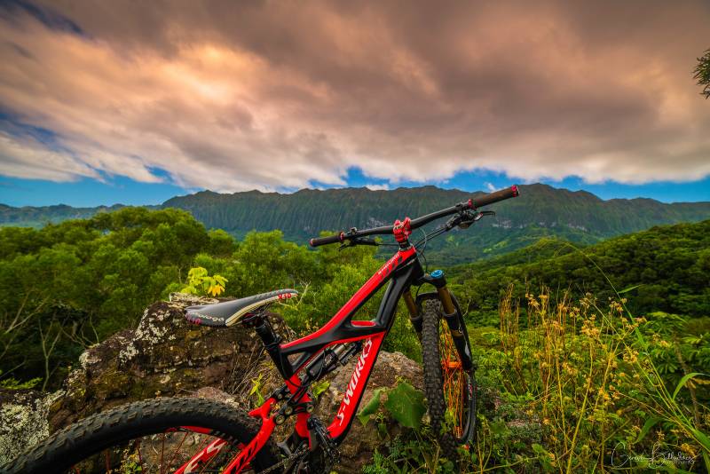 photo: red MTB bicycle parked overlooking lush interior valley in Hawaii